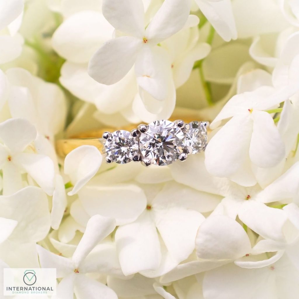 engagement ring on white flowers